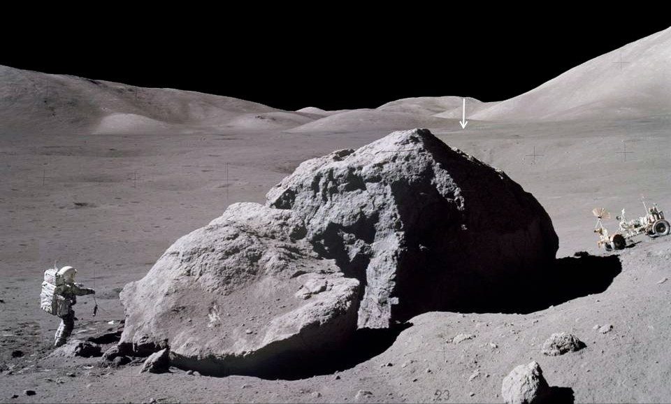 El tiempo de superficie del Apolo 17, el programa de mayor duración en la Luna, fue de tres días, dos horas y cincuenta y nueve minutos.  La imagen muestra a Jack Schmidt de la nave espacial Apolo 17 llevando un escorpión hacia el módulo lunar después de observar y tomar muestras del lado este de una enorme roca.  La flecha vertical en la distancia apunta al Módulo Lunar Challenger, ubicado a unas 2 millas (3,1 km) de distancia.